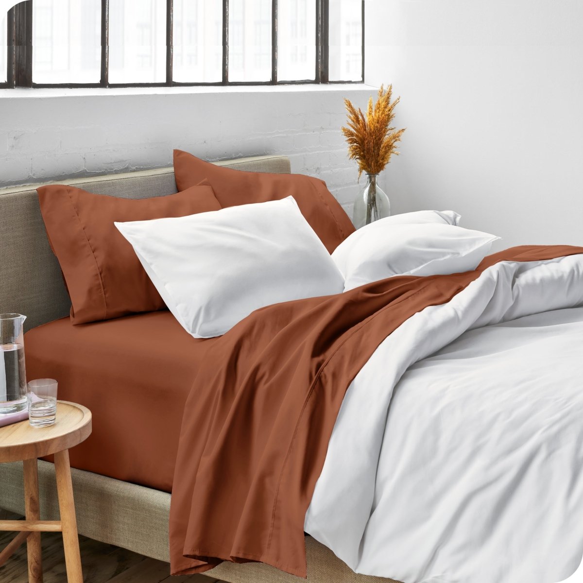 Sheets and a duvet cover on a bed in a bright bedroom