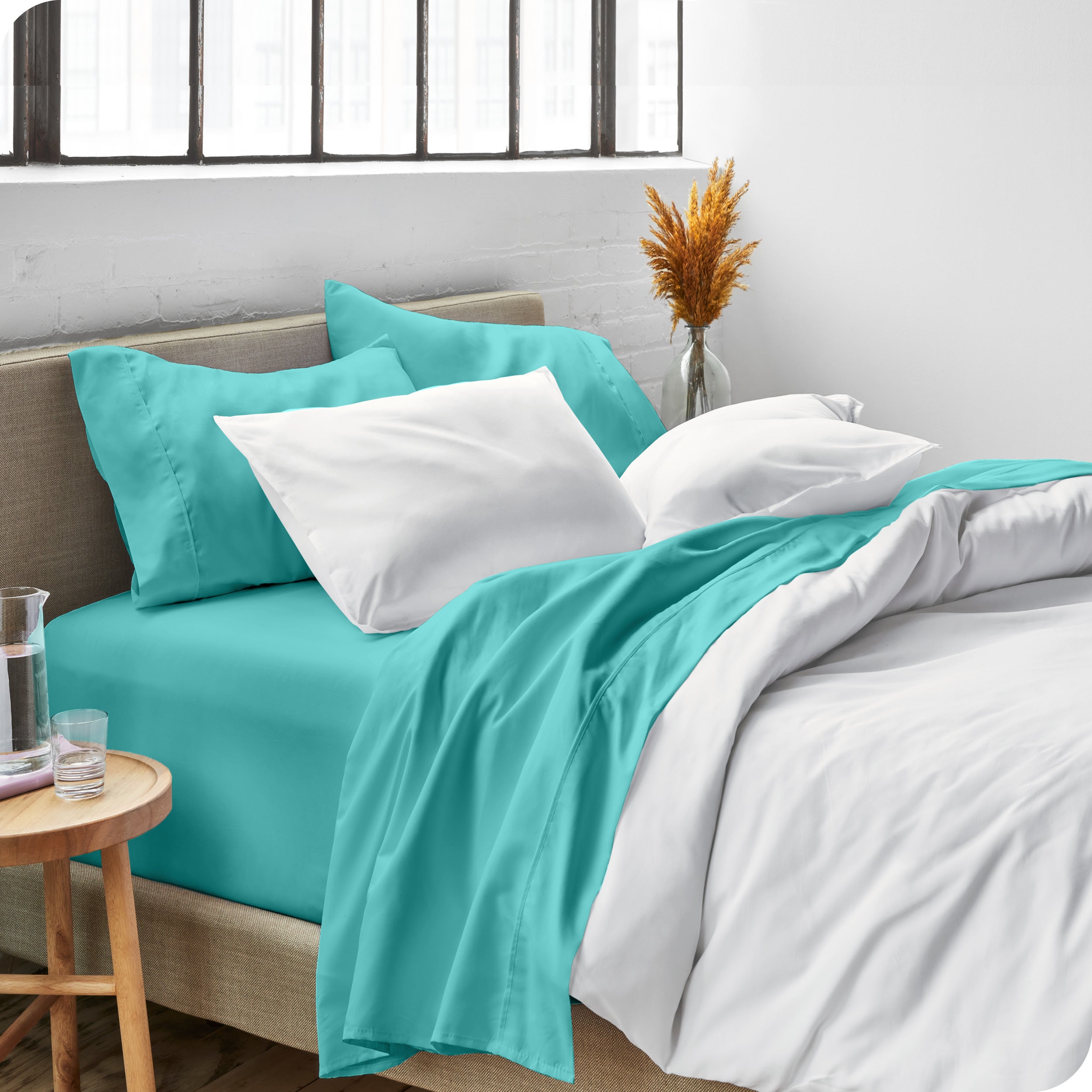 Sheets and a duvet cover on a bed in a bright bedroom