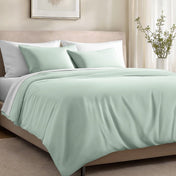 Bed with organic cotton sateen bedding in a bedroom setting.