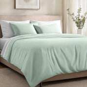 Bed with organic cotton sateen bedding in a bedroom setting.