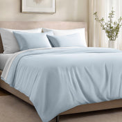Bed with organic cotton sateen bedding in a bedroom setting.
