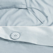Close-up of a sateen duvet cover with a button and ties