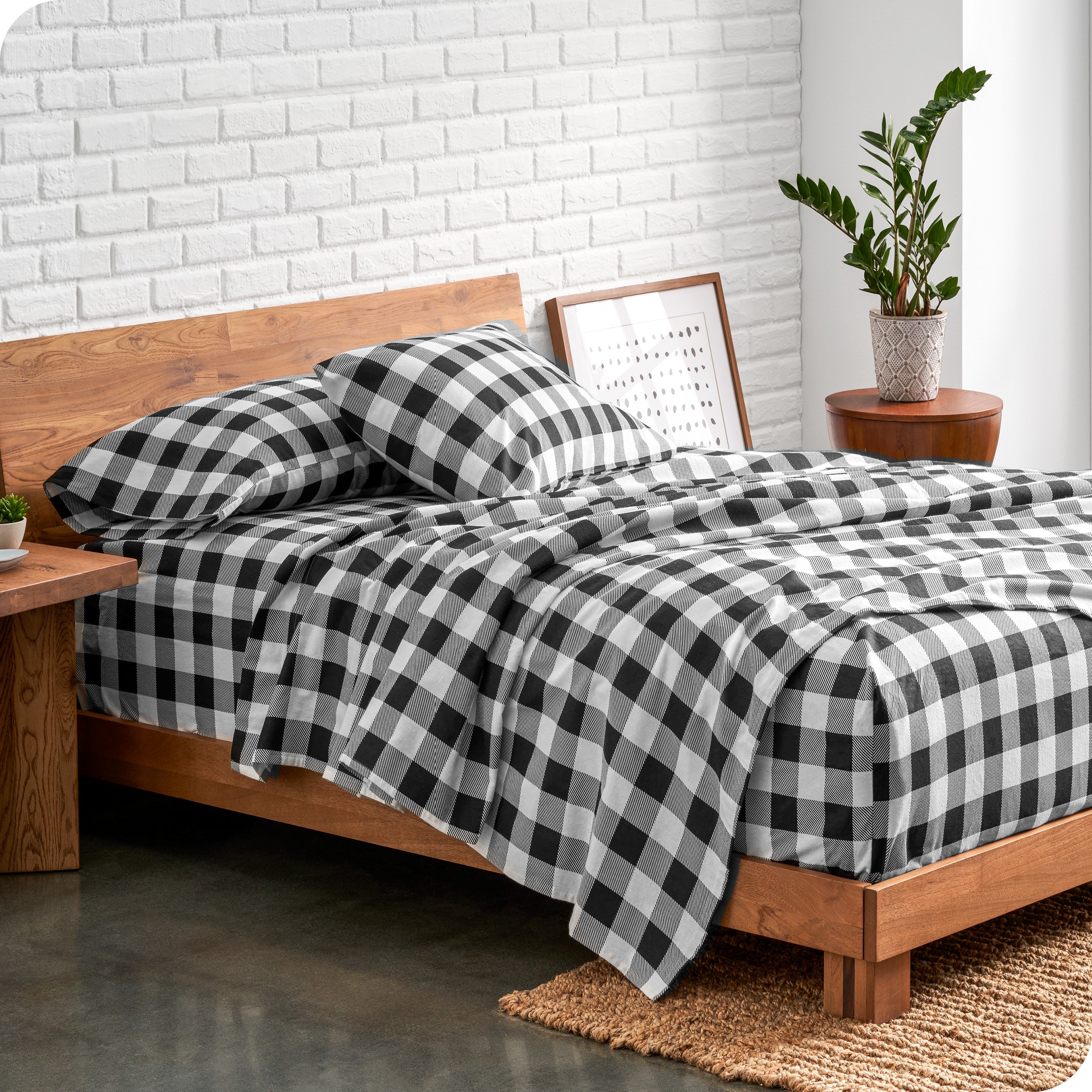 A bed made with printed flannel sheets