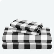 Flannel print sheet set folded and stacked neatly on a white background