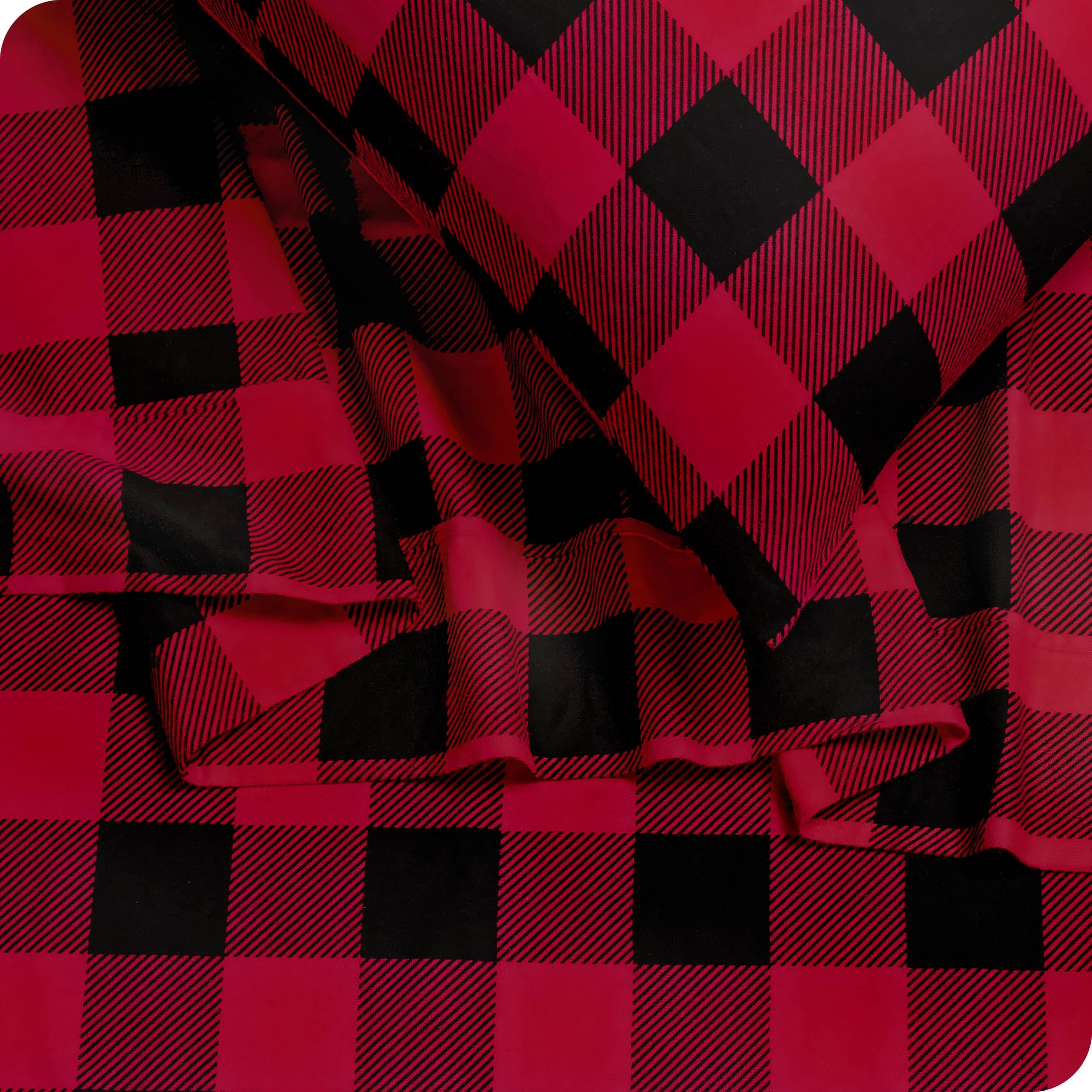 Close up of a pillowcase and sheets in red and black plaid print