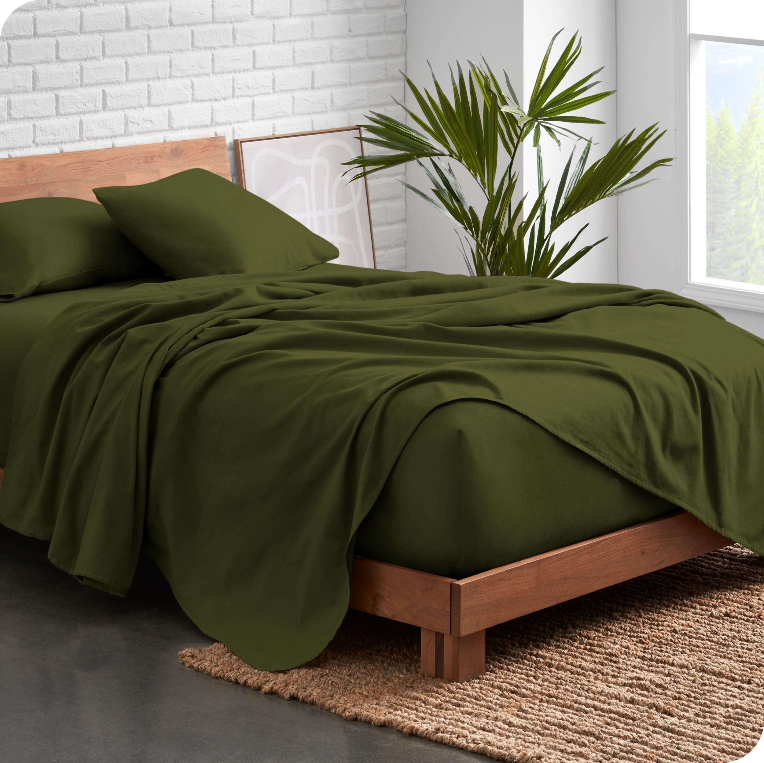 Modern wood bed frame with green organic flannel sheets and pillowcases