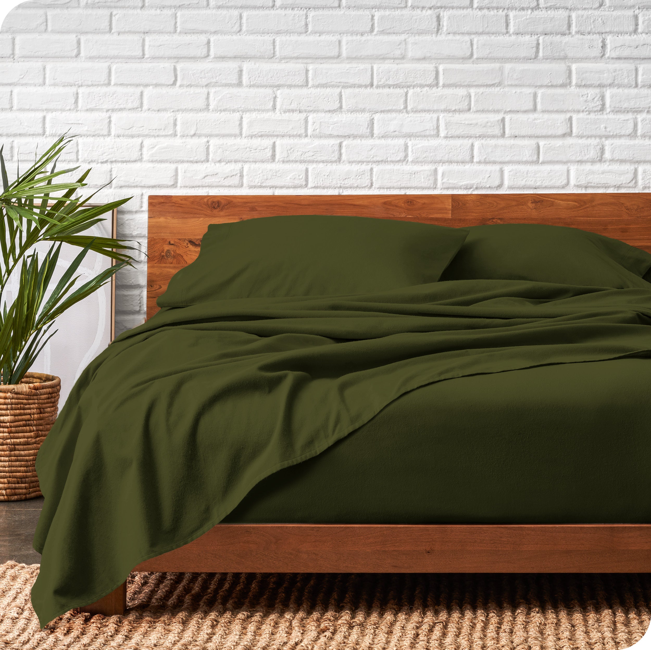 Modern wood bed frame with green organic flannel sheets and pillowcases