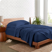 A modern bedroom with blue organic jersey sheets on the mattress