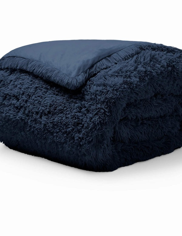 A dark blue shaggy duvet cover folded neatly