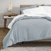 A modern bed with an organic sateen duvet cover set on.