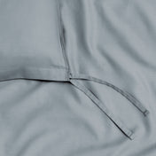 A close view of the tie corner and texture of the duvet cover.