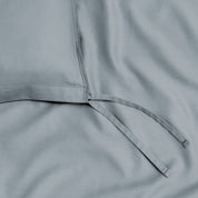 A close view of the tie corner and texture of the duvet cover.