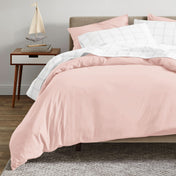 A modern bed with an organic sateen duvet cover set on.