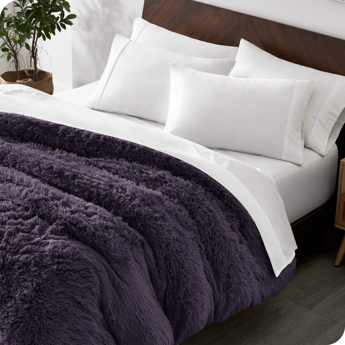 A modern bedroom with a shaggy duvet cover on the bed.