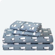 Flannel print sheet set folded and stacked neatly on a white background