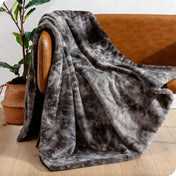 Faux fur blanket draped over a brown couch