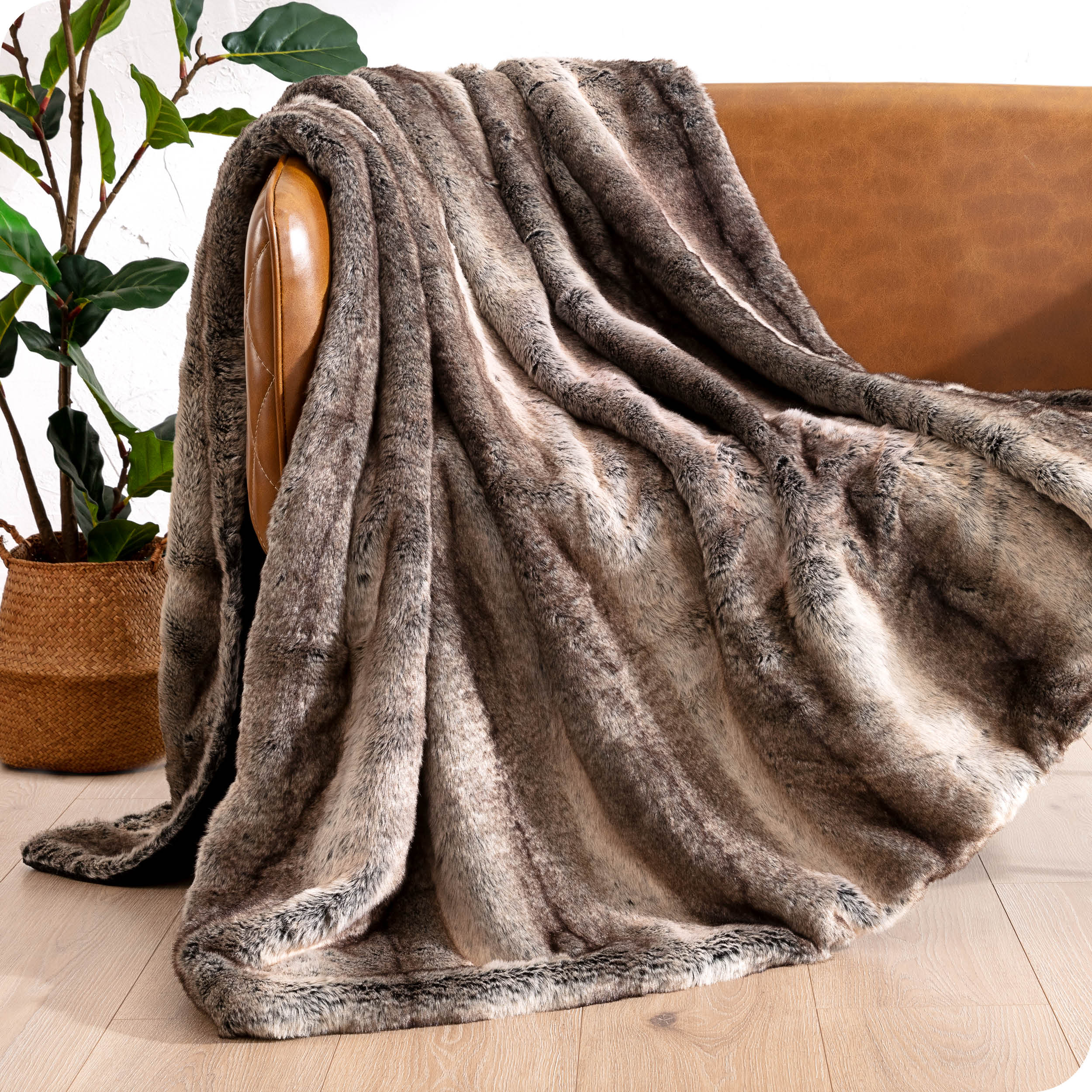 Faux fur blanket draped over a brown couch