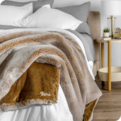 Faux fur blanket draped over the corner of a bed