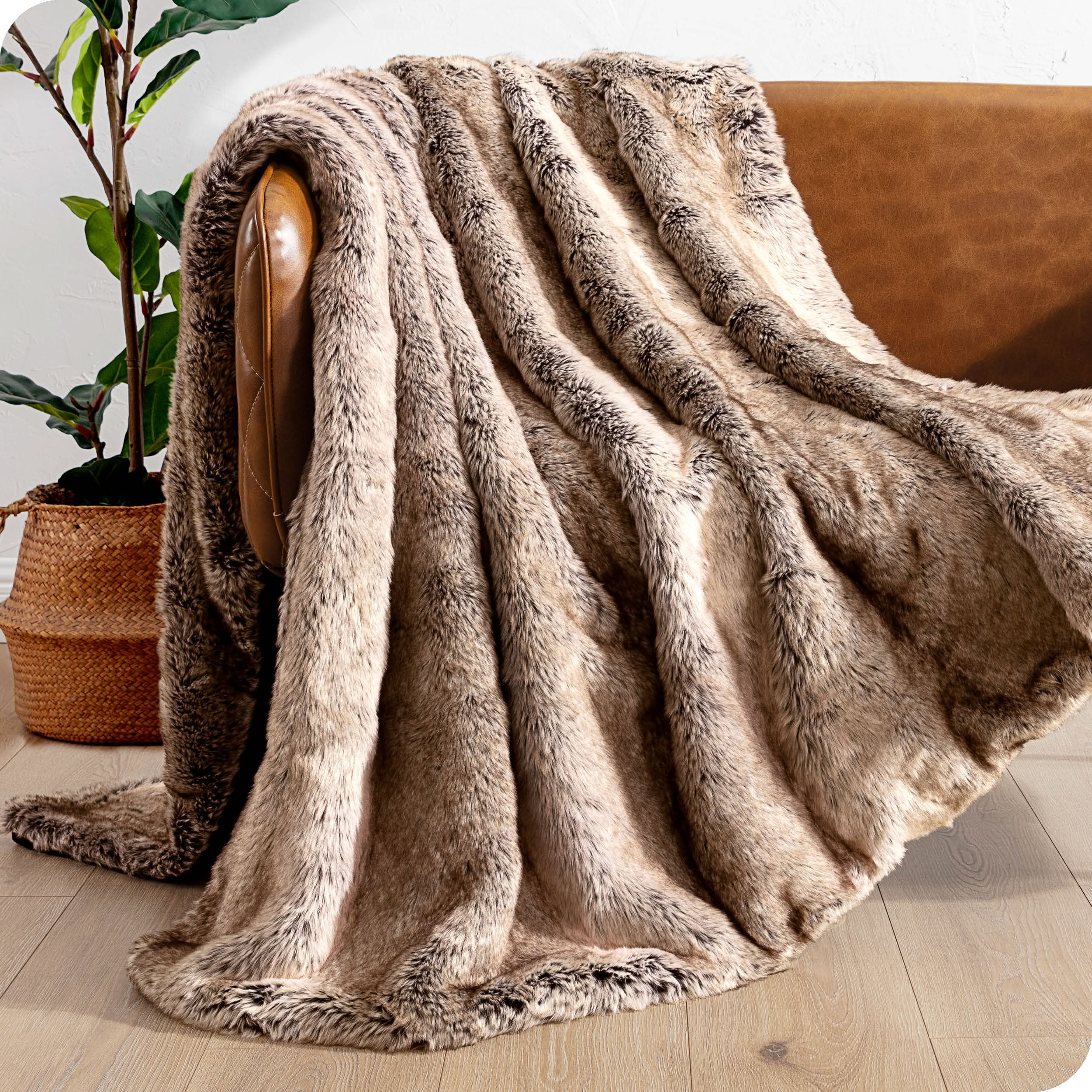 Faux fur blanket draped over a brown couch