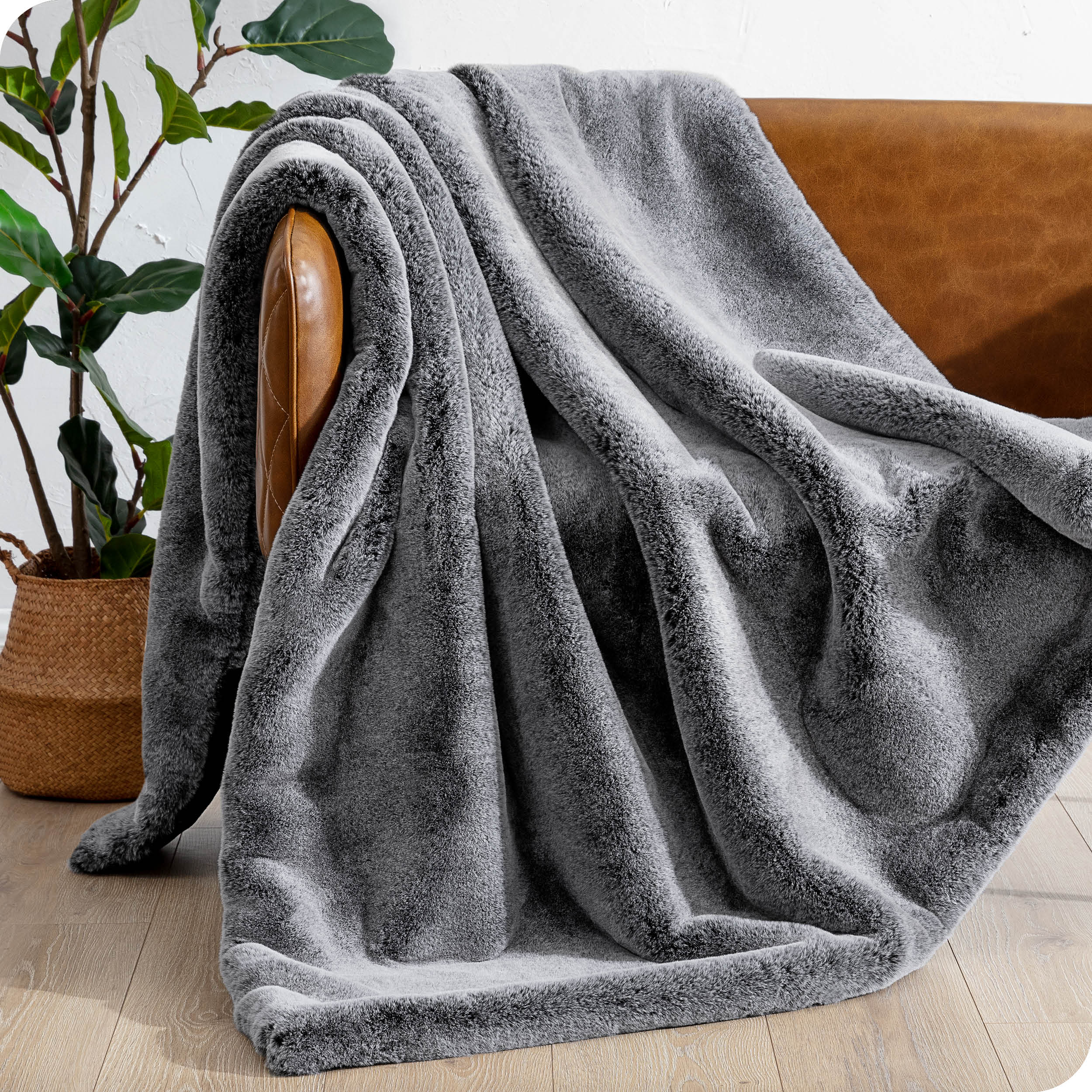 Faux fur blanket draped over a brown couch