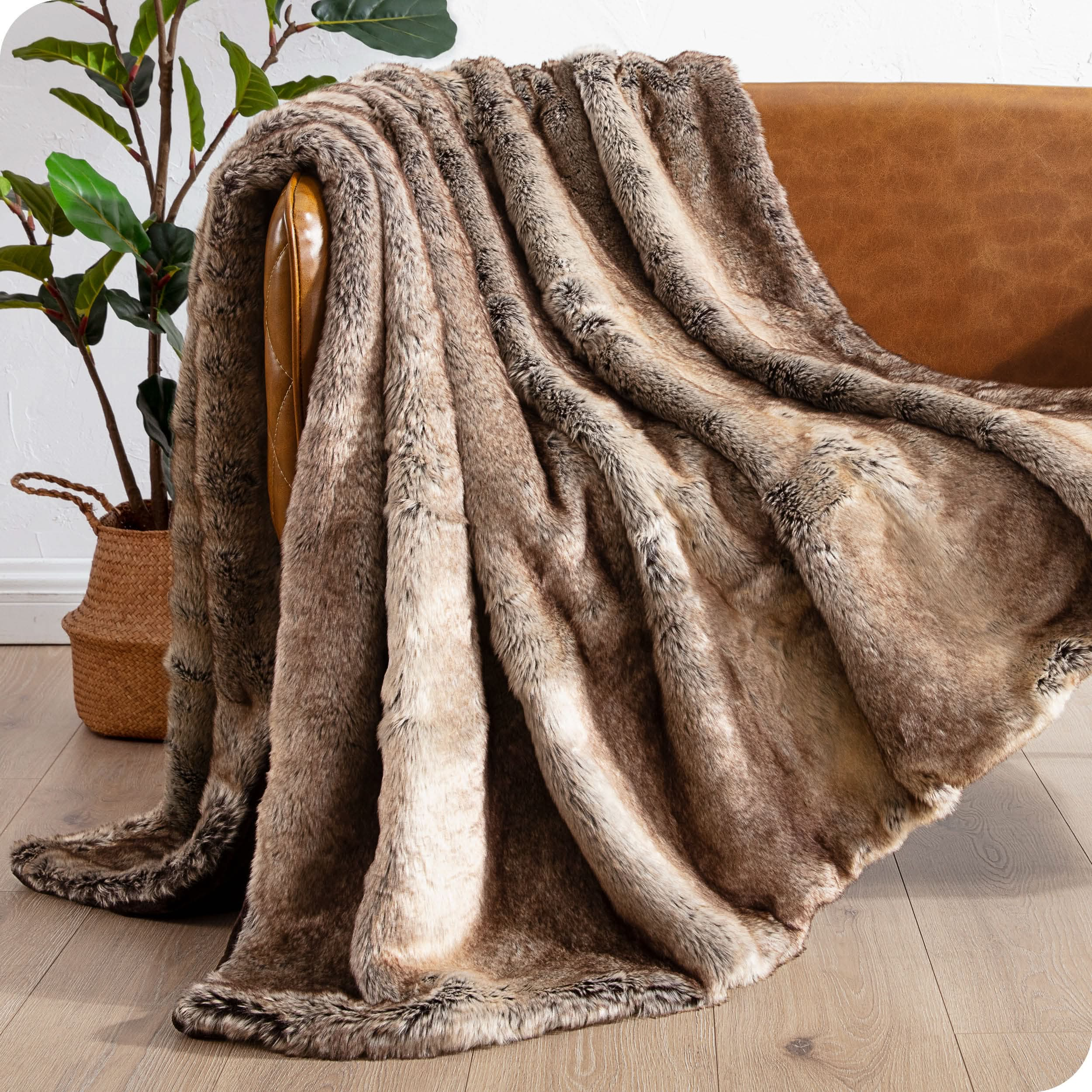 Faux fur blanket draped over a brown couch