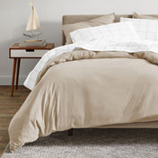 A modern bed with an organic sateen duvet cover set on.