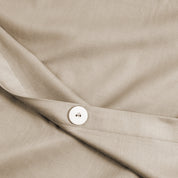 A close view of the texture and buttons of the duvet cover.