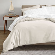 A modern bed with an organic sateen duvet cover set on.