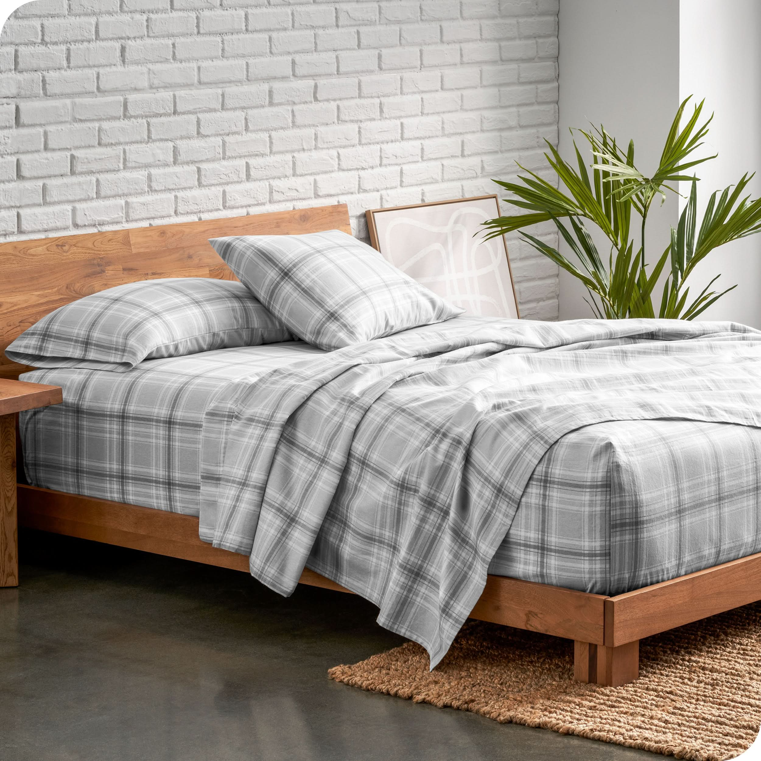 A bed made with printed flannel sheets