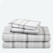 Flannel print sheet set folded and stacked neatly on a white background