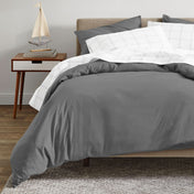 A modern bed with an organic sateen duvet cover set on.