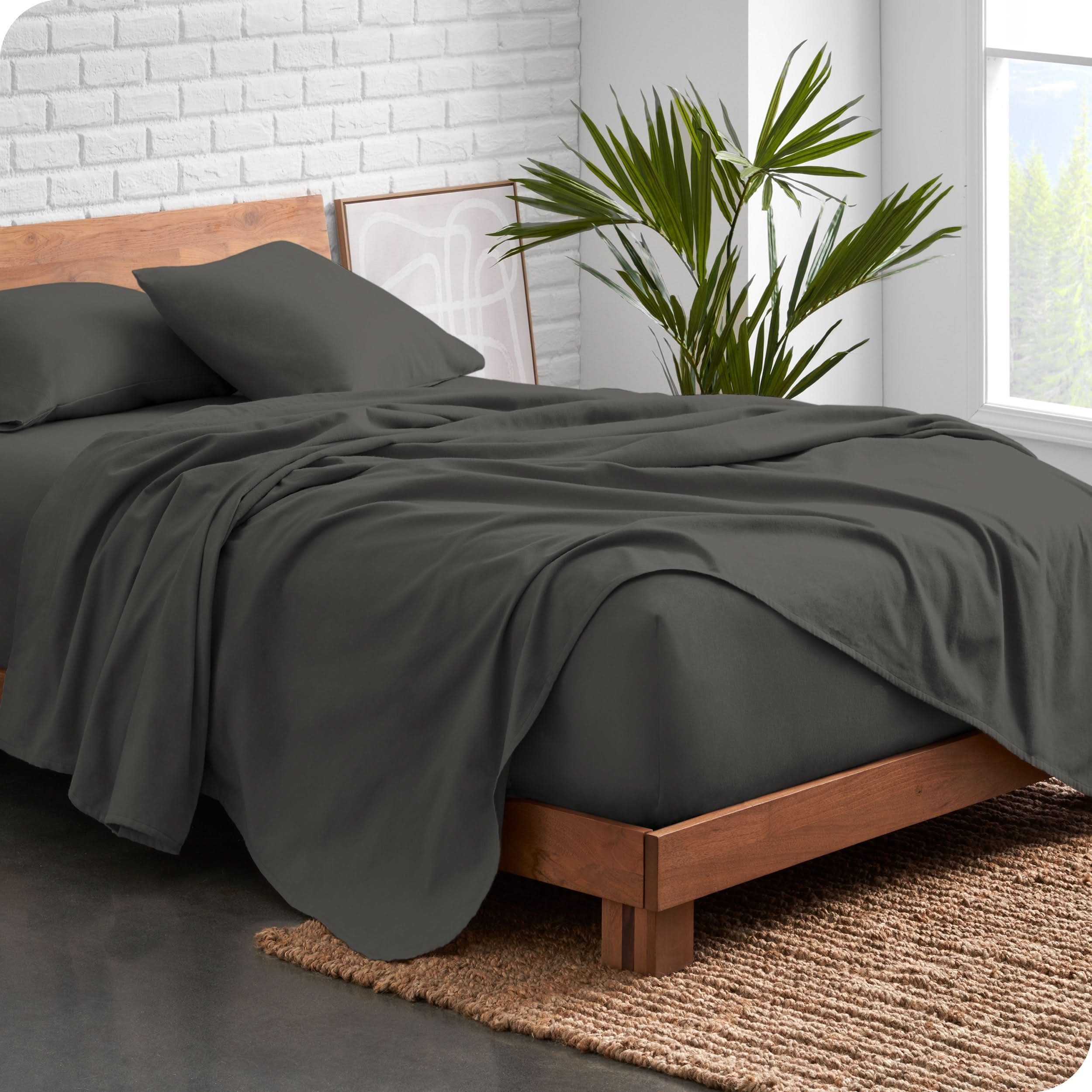 Modern wood bed frame with grey organic flannel sheets and pillowcases