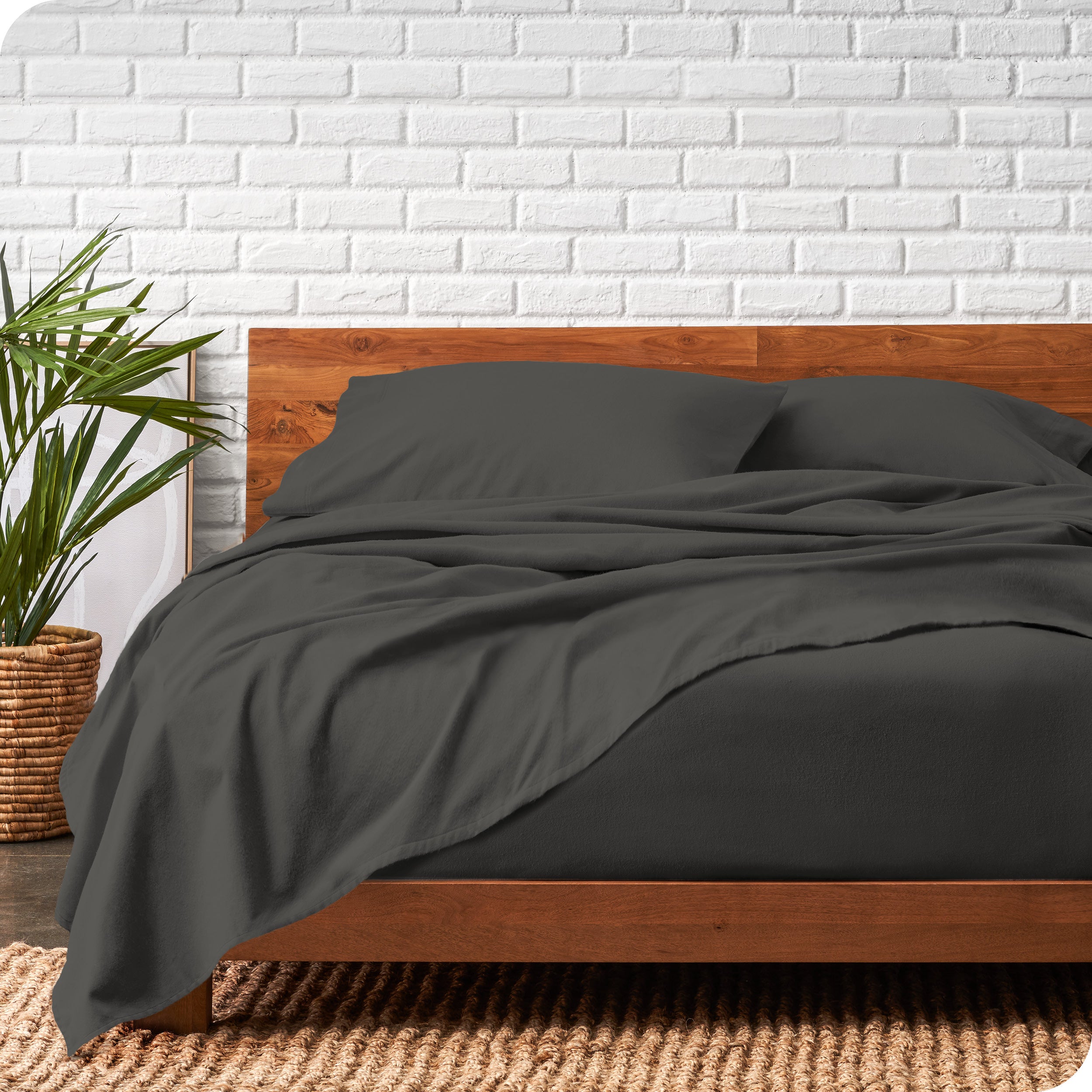 Modern wood bed frame with grey organic flannel sheets and pillowcases