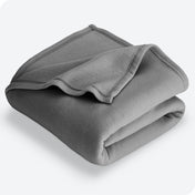 Grey polar fleece blanket folded with 1 corner folded back