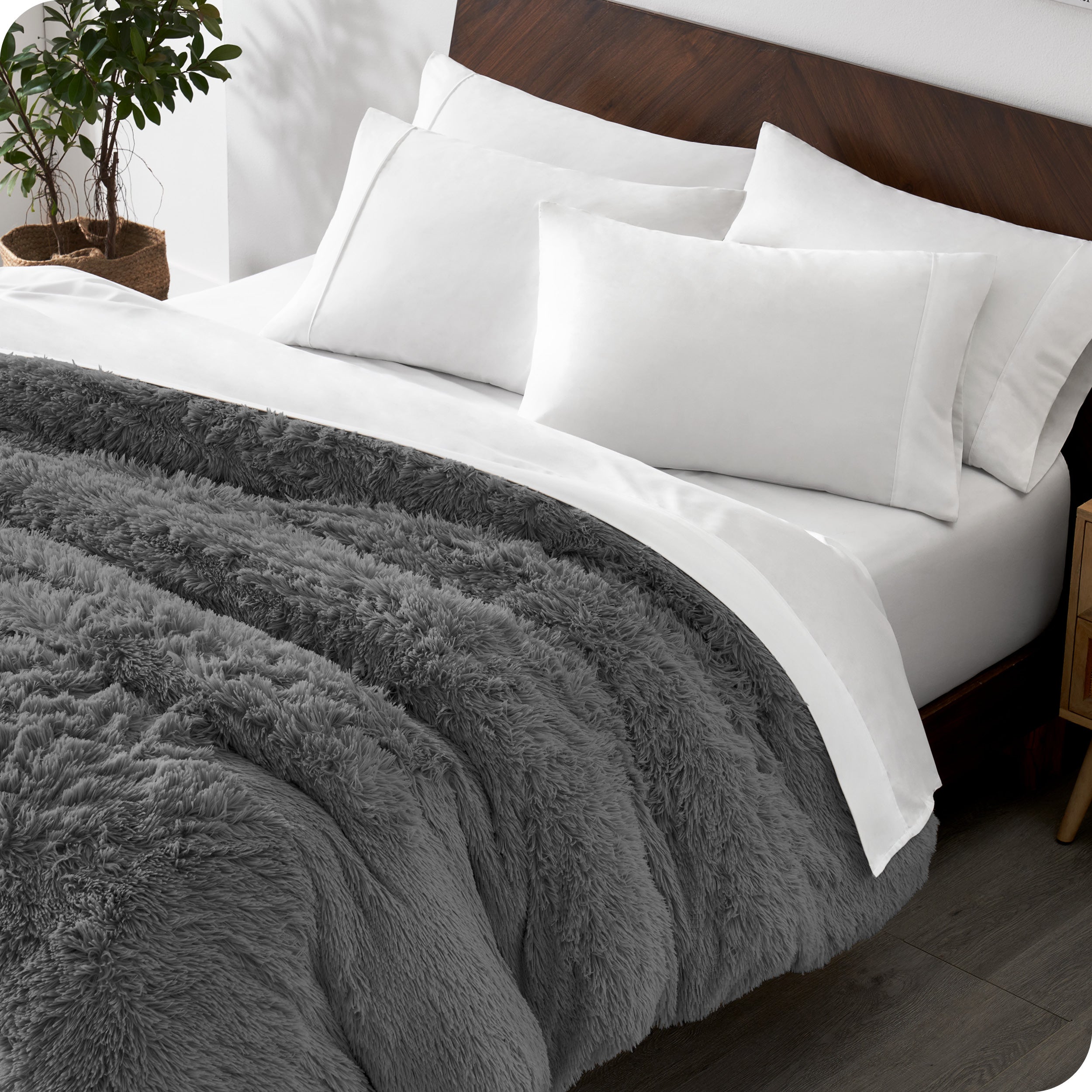 A modern bedroom with a shaggy duvet cover on the bed.