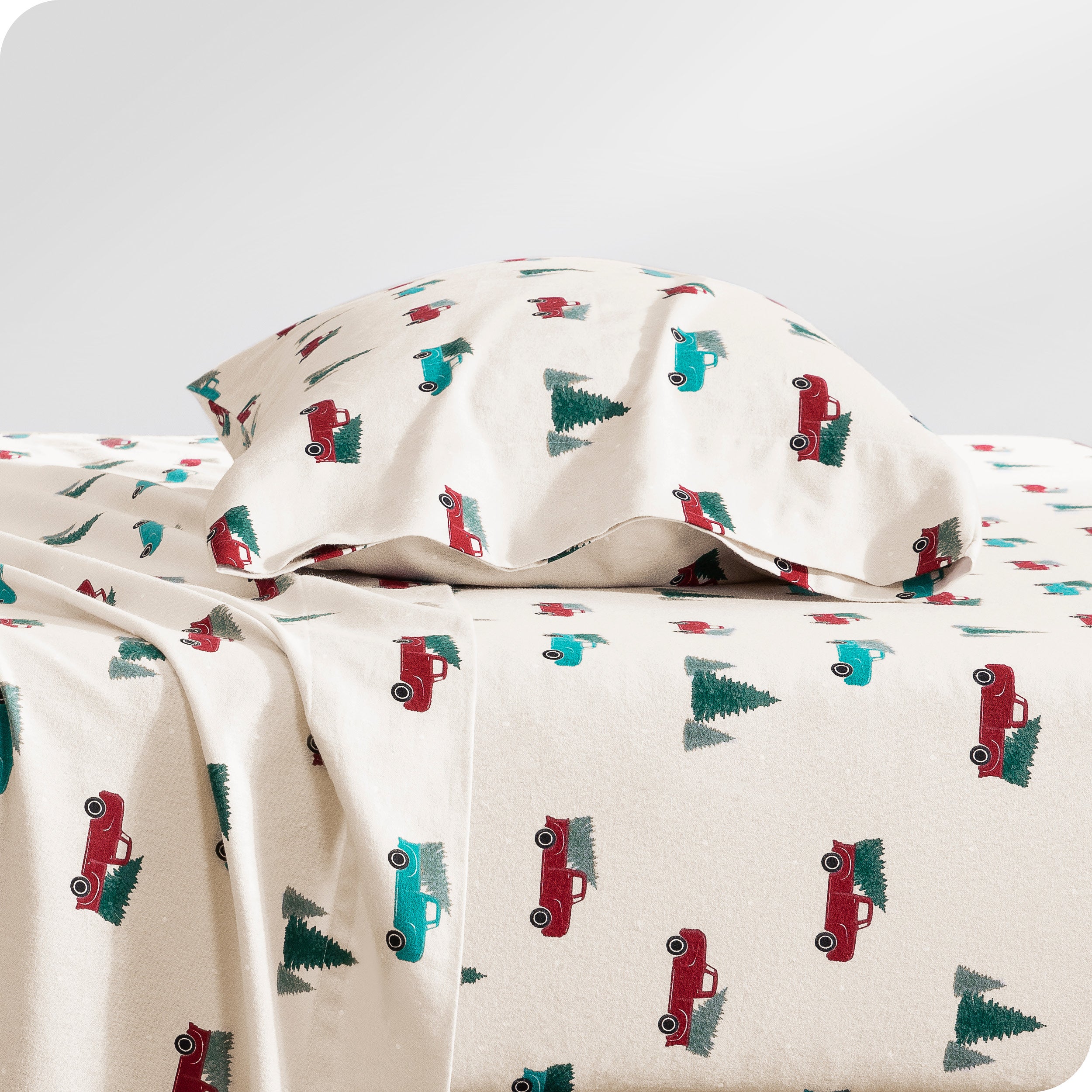 Flannel pillowcase with pillow inside stacked on a bed made with matching flannel sheets