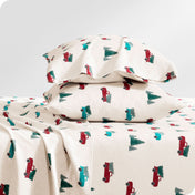 Flannel pillowcase with pillow inside stacked on a bed made with matching flannel sheets