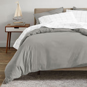 A modern bed with an organic sateen duvet cover set on.