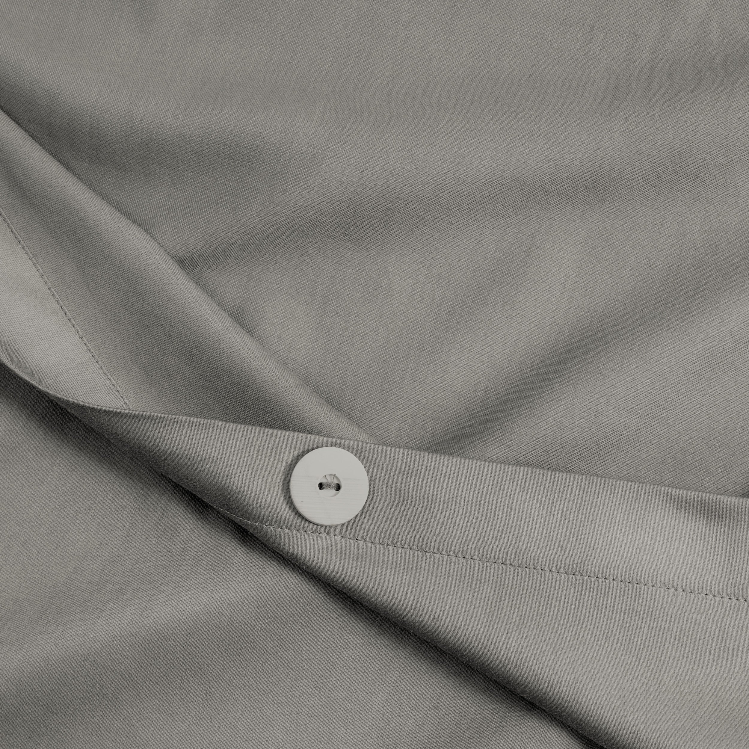 A close view of the texture and buttons of the duvet cover.