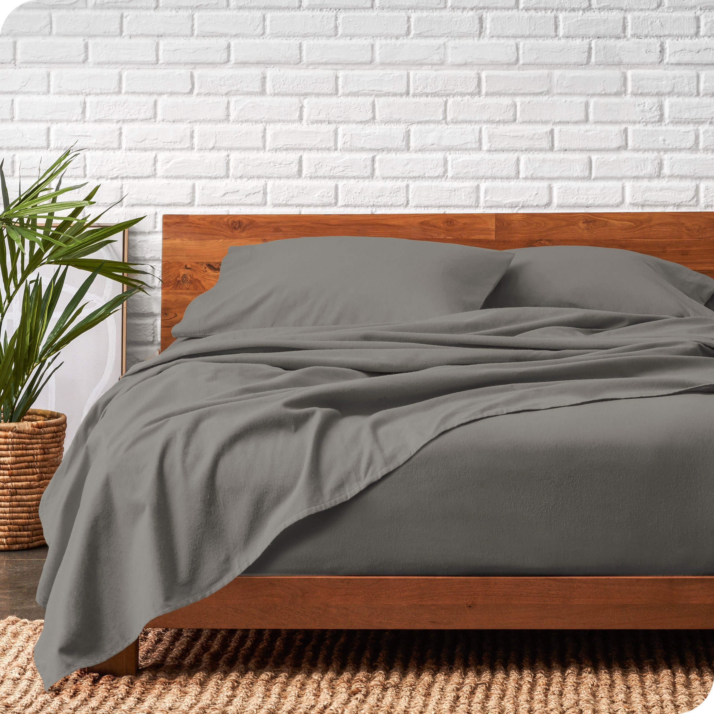 Modern wood bed frame with grey organic flannel sheets and pillowcases