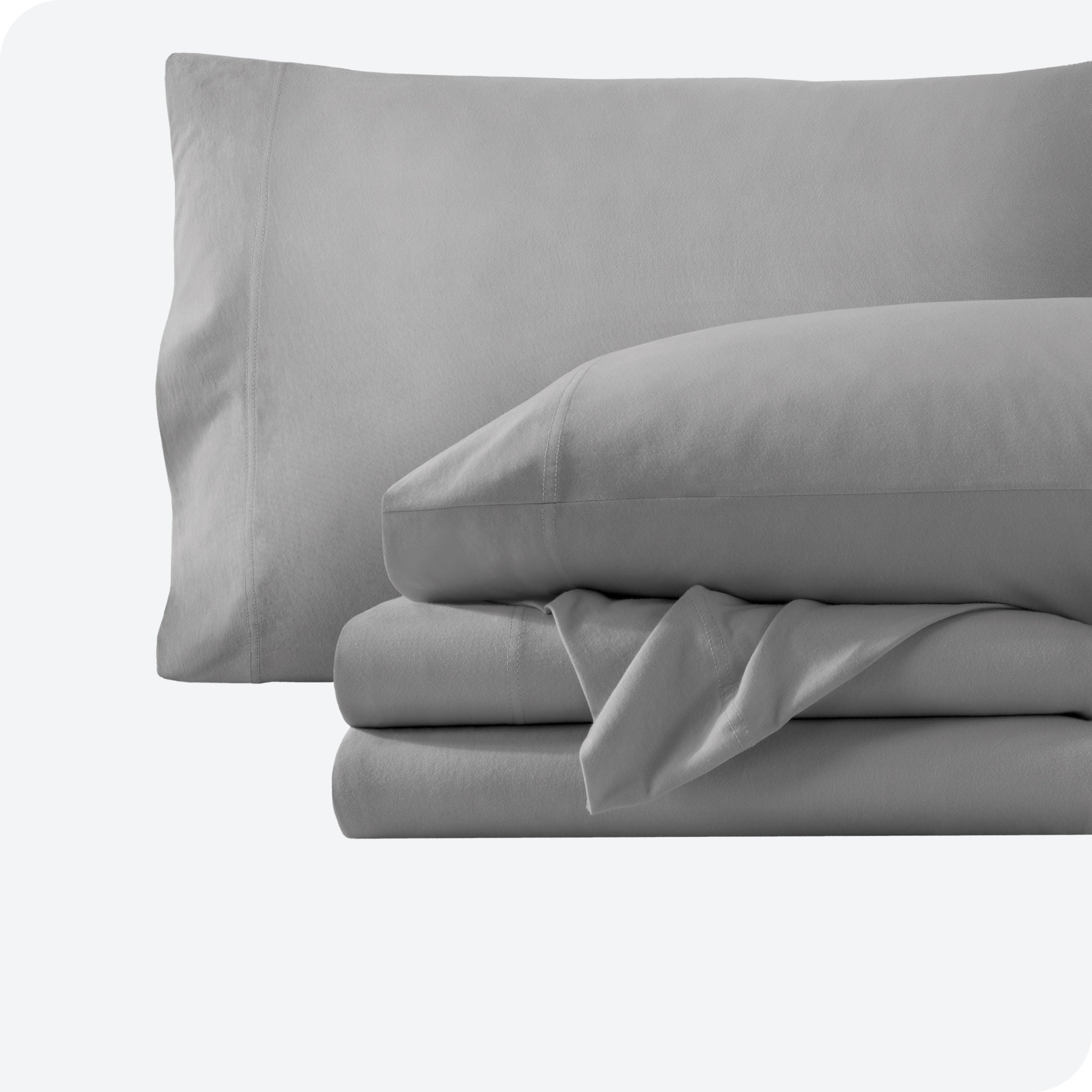 A light grey sheet set folded and stacked