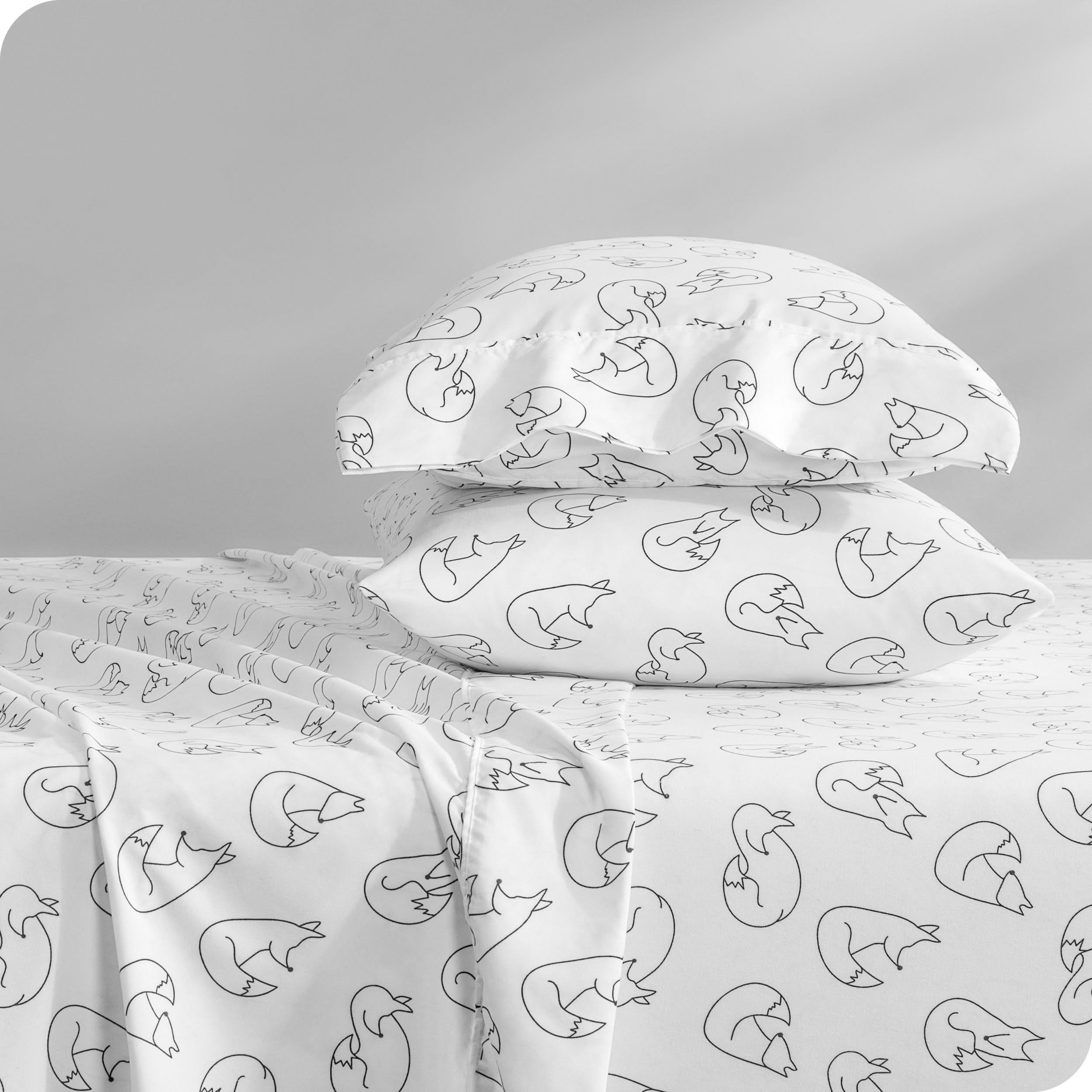 A sideview of a bed with two pillows stacked in our microfiber sheet sets with a print/pattern.