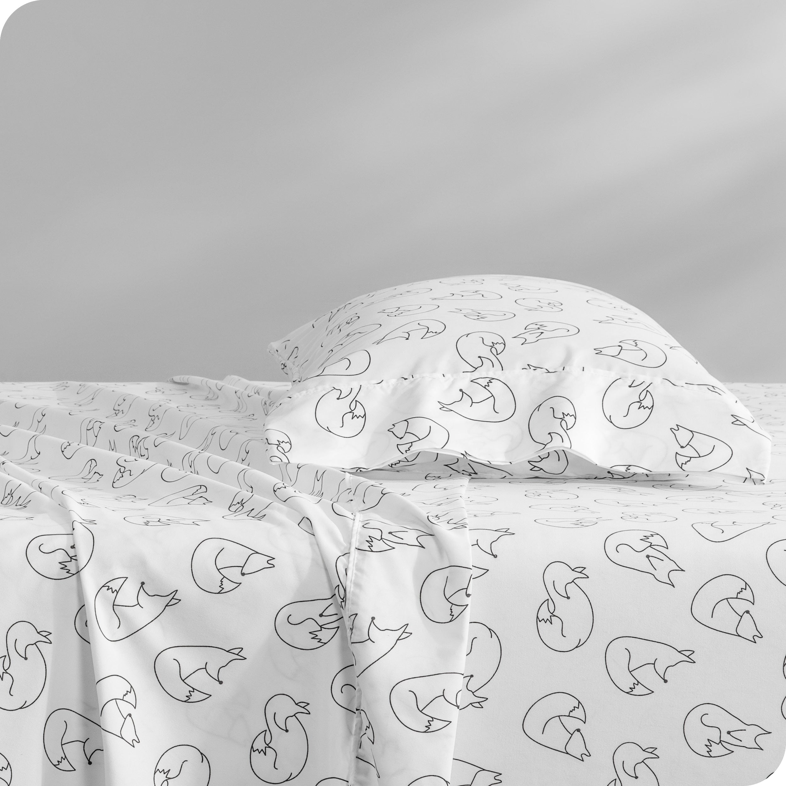 A sideview of a bed with one pillow in our printed microfiber sheet set.