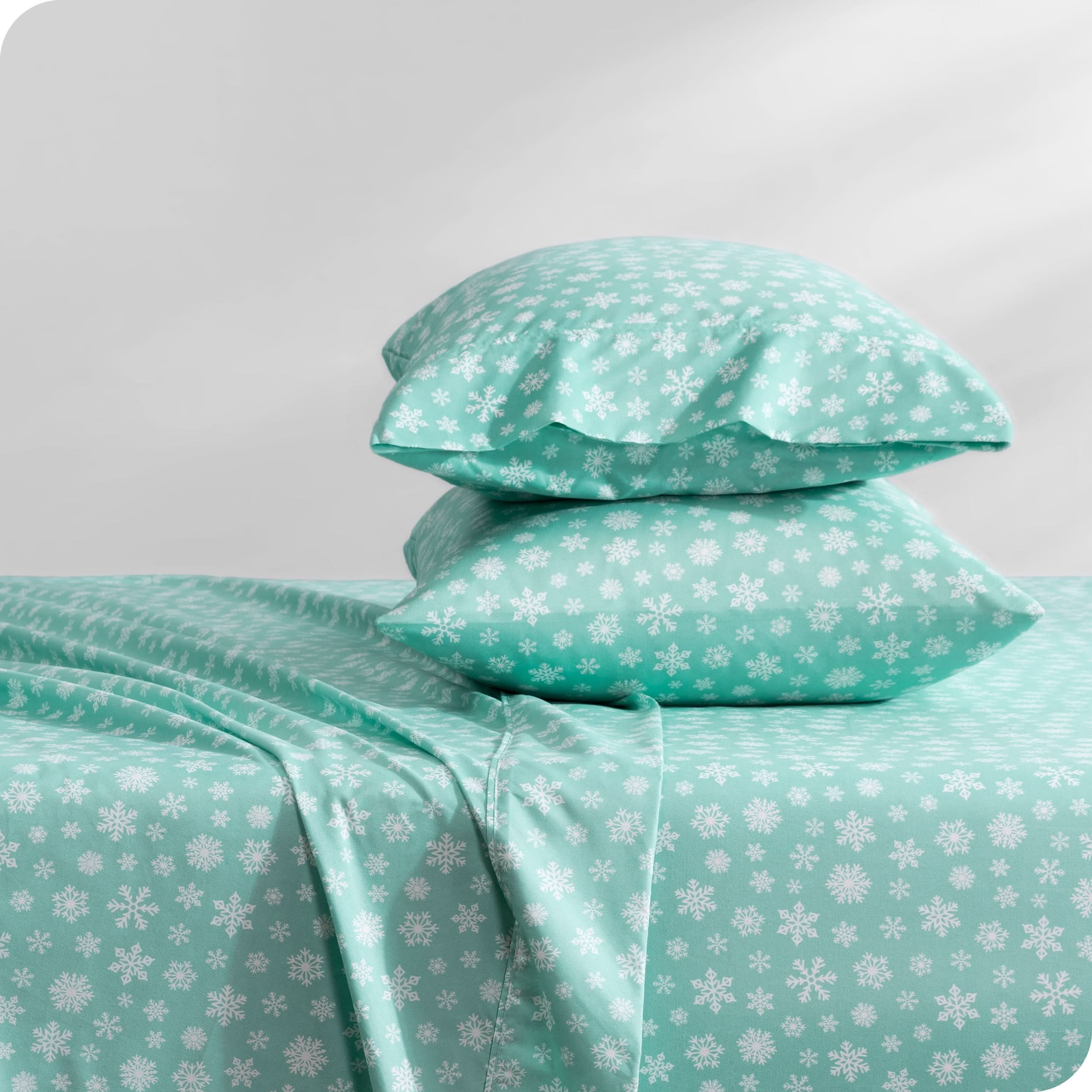 A sideview of a bed with two pillows stacked in our microfiber sheet sets with a print/pattern.