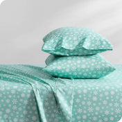 A sideview of two stacked pillows on a bed with our microfiber printed sheet.