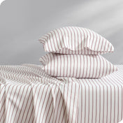 A side view of two pillows stacked on a bed with a microfiber printed set