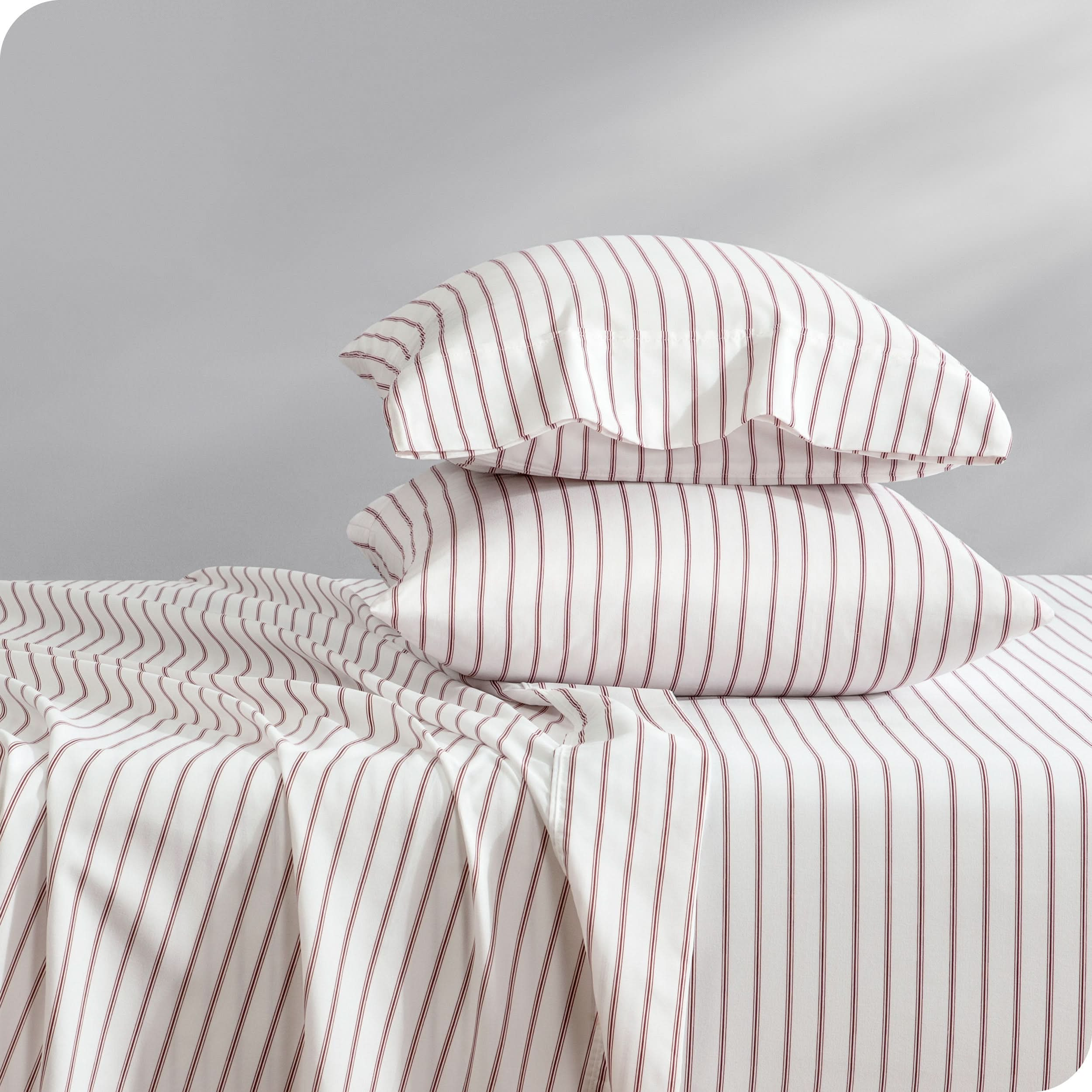 A sideview of a bed with two pillows stacked in our microfiber sheet sets with a print/pattern.