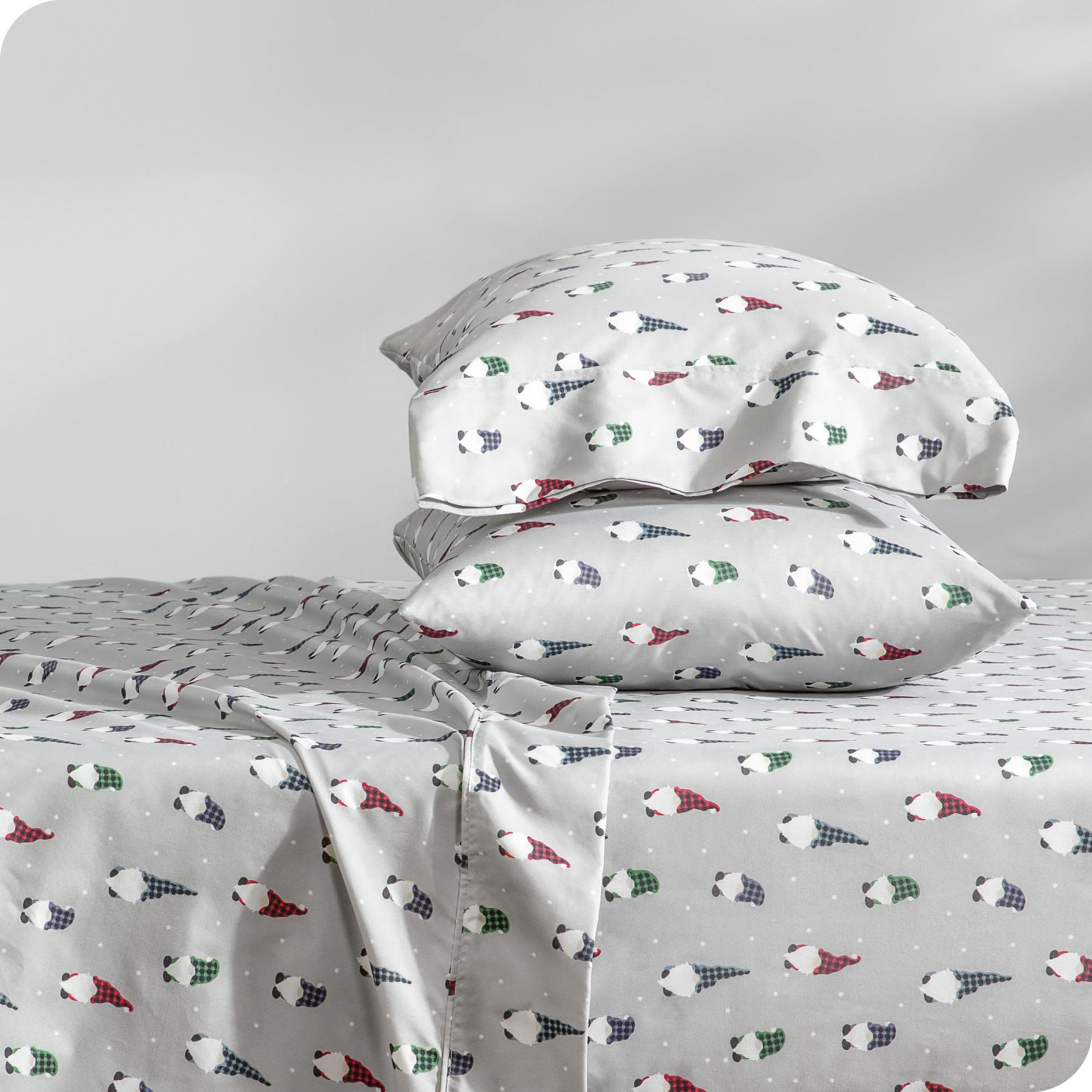 A sideview of a bed with two pillows stacked in our microfiber sheet sets with a print/pattern.