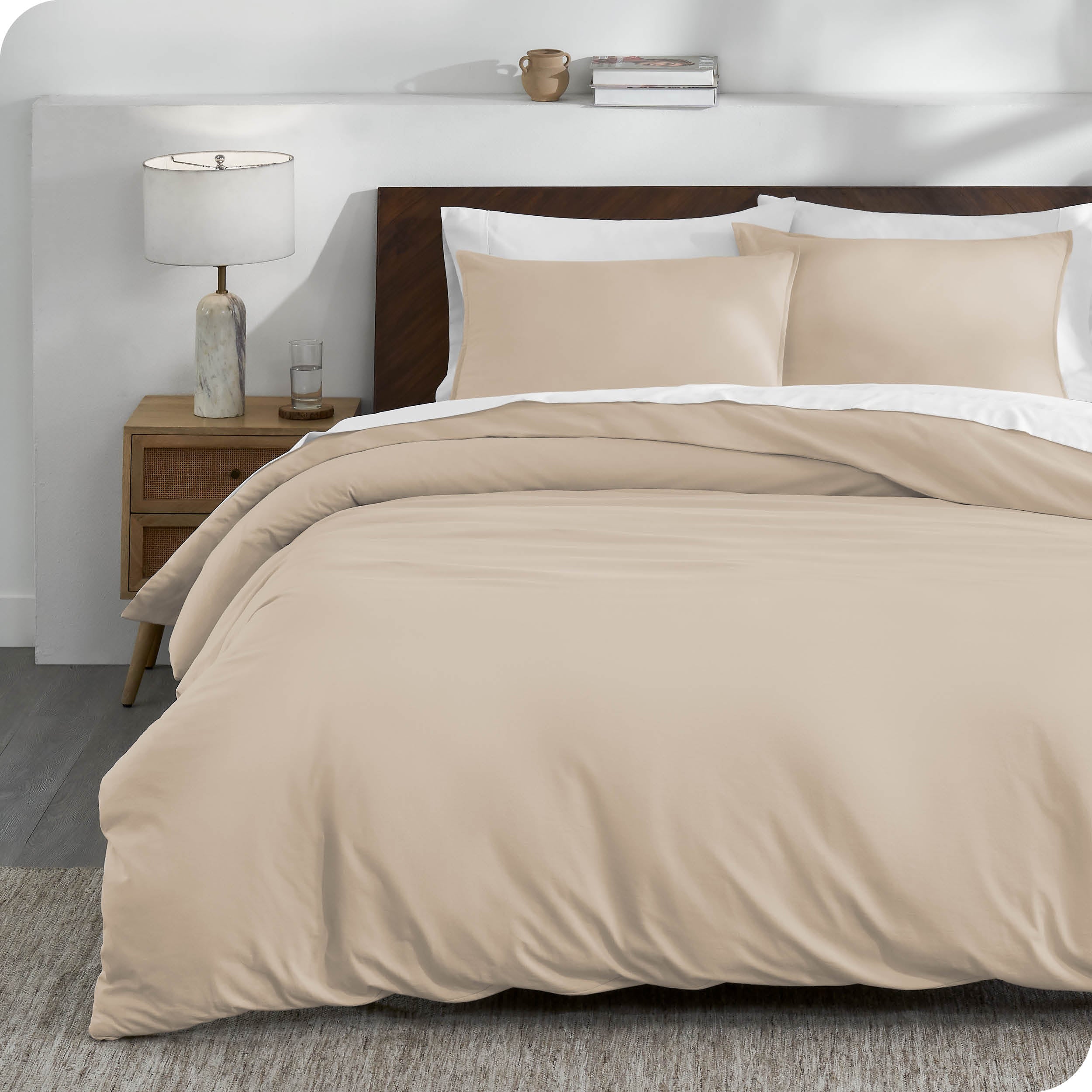 A sand organic cotton jersey duvet cover on a bed made with a white bedding