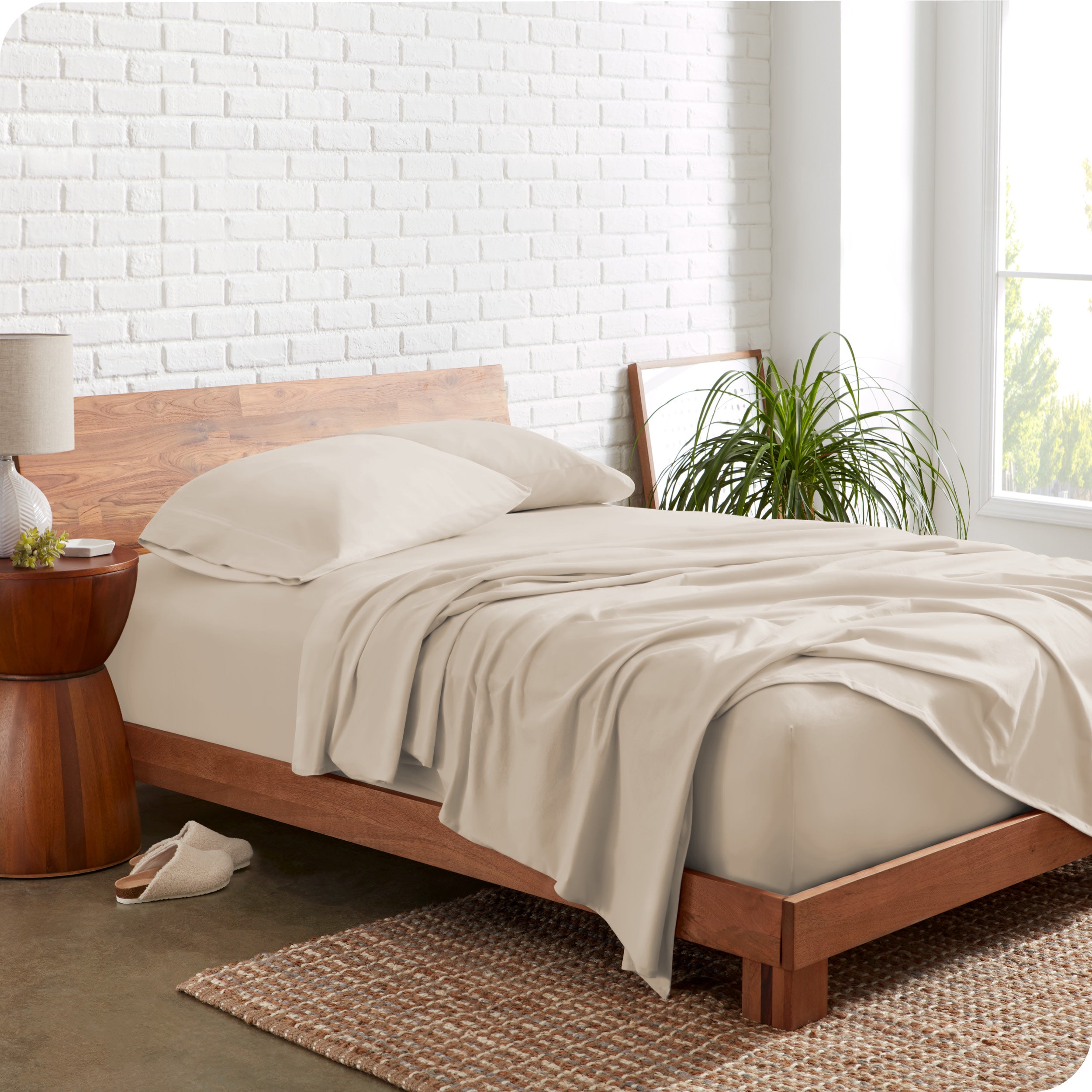 A modern bedroom with sand organic jersey sheets on the mattress